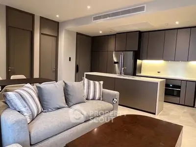 Modern open-plan living room and kitchen with sleek cabinetry and stylish decor.