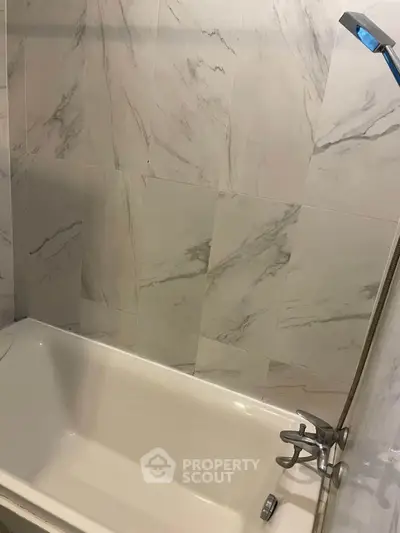 Modern bathroom with marble tiles and sleek bathtub