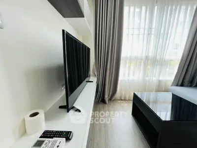 Modern living room with sleek TV setup and large window with curtains