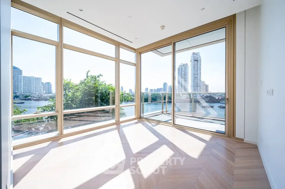 Stunning corner unit with panoramic city and river views, featuring floor-to-ceiling windows and elegant wood flooring.
