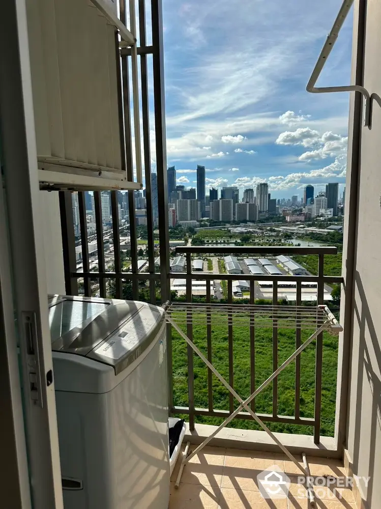 High-rise balcony with washing machine and stunning city skyline view