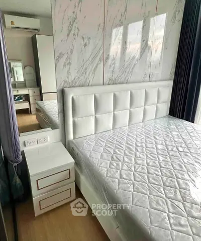 Modern bedroom with elegant white decor and marble accent wall