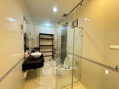 Spacious modern bathroom with glass shower and sleek fixtures