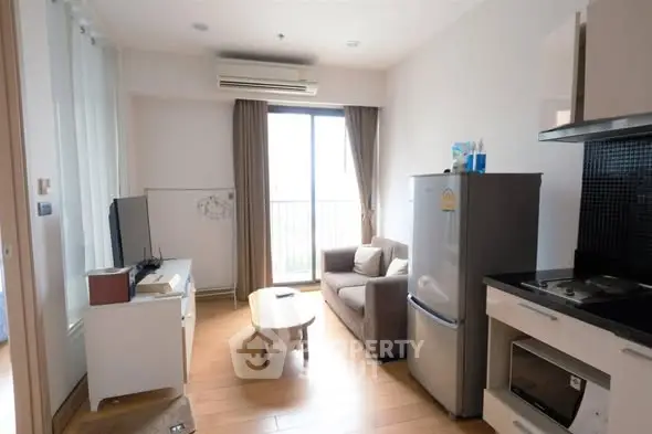 Modern living room with balcony access and compact kitchen area