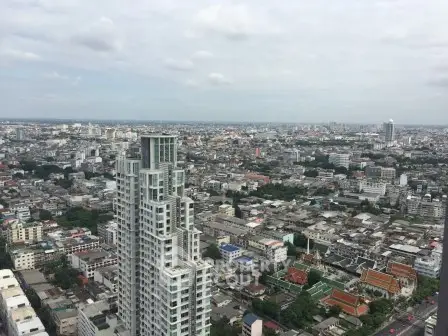 Stunning cityscape view from a high-rise building showcasing urban skyline and architectural diversity.