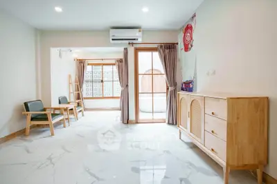 Spacious living room with modern furniture and large windows for natural light.