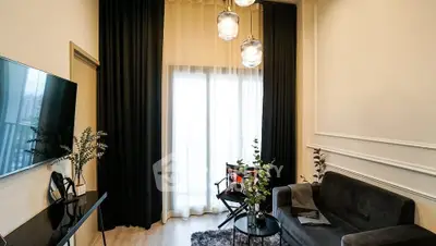 Modern living room with elegant decor and large window, featuring stylish furniture and ambient lighting.
