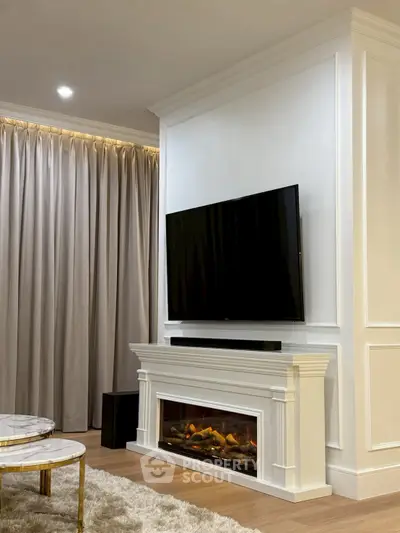 Elegant living room with modern fireplace and mounted TV, featuring luxurious curtains and stylish decor.