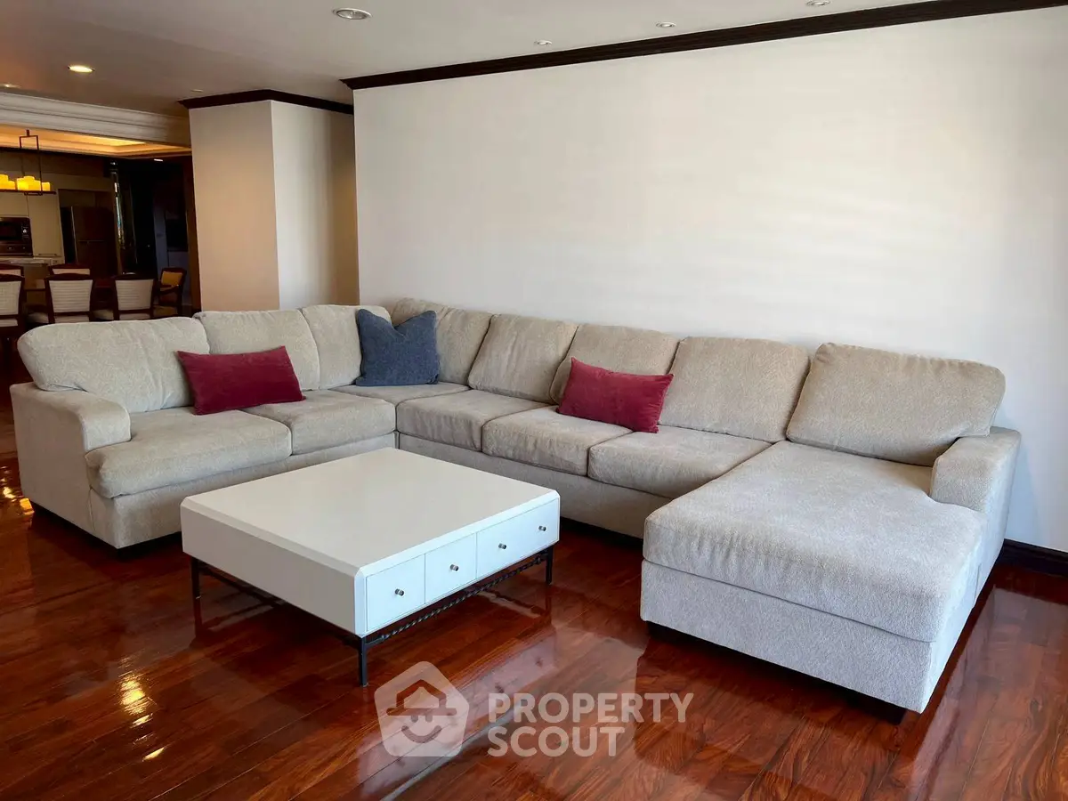 Spacious living room with elegant sectional sofa and polished wooden floors