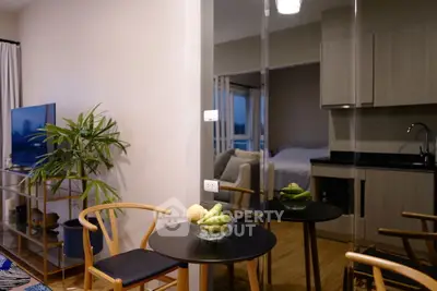 Modern open-plan living room with dining area and sleek kitchen design