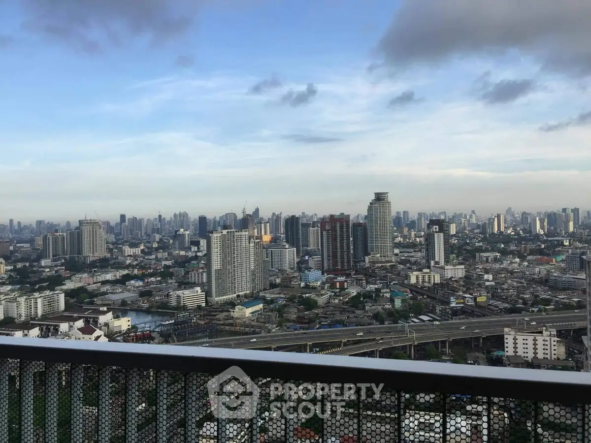 Stunning cityscape view from a high-rise balcony, showcasing urban skyline and expansive horizon.