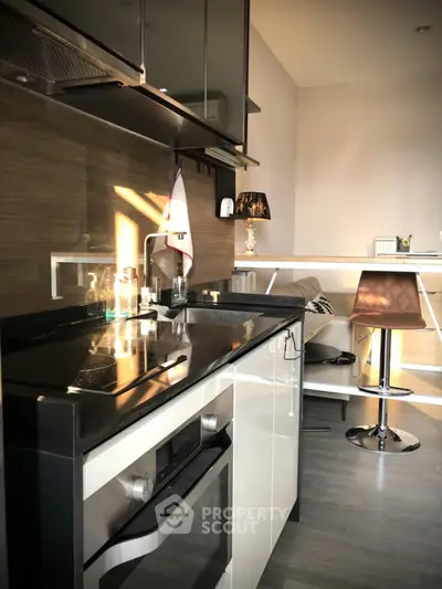 Modern kitchen with sleek black countertops and built-in oven