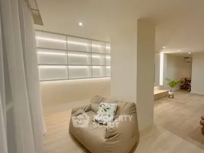 Modern living space with cozy bean bag and ambient lighting, perfect for relaxation.