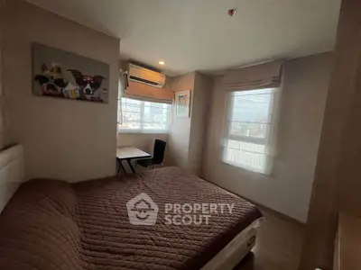 Cozy bedroom with large windows and modern decor in a stylish apartment.
