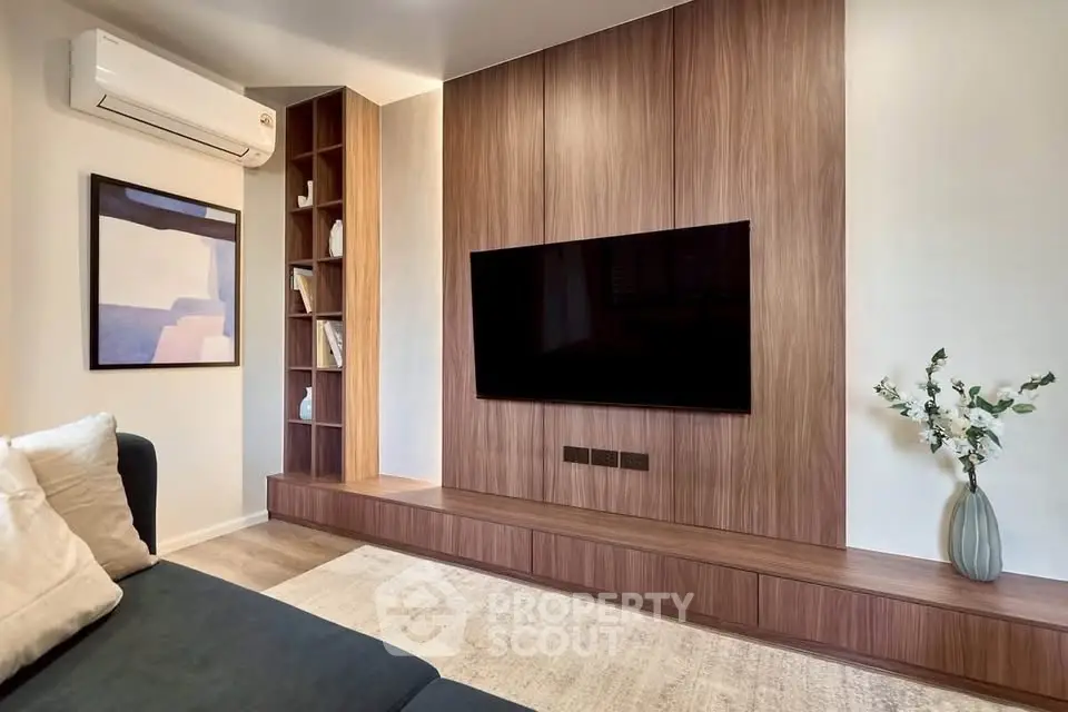 Modern living room with sleek wooden paneling and wall-mounted TV