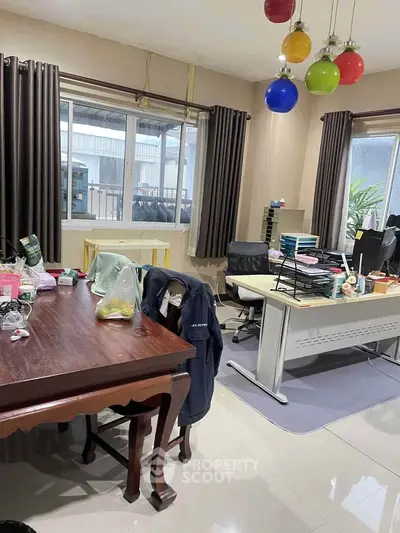 Spacious office space with modern furniture and colorful lighting, ideal for productivity.