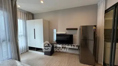 Modern apartment interior with sleek furniture and stainless steel fridge