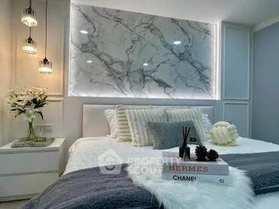 Luxurious bedroom with elegant marble accent wall and designer decor