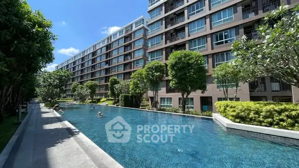 Luxurious condominium with a stunning outdoor pool and lush greenery, perfect for relaxation and leisure.