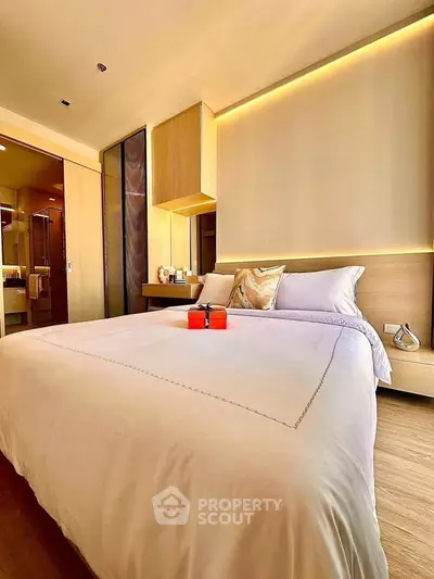 Luxurious bedroom with modern design and ambient lighting, featuring a cozy bed and elegant decor.