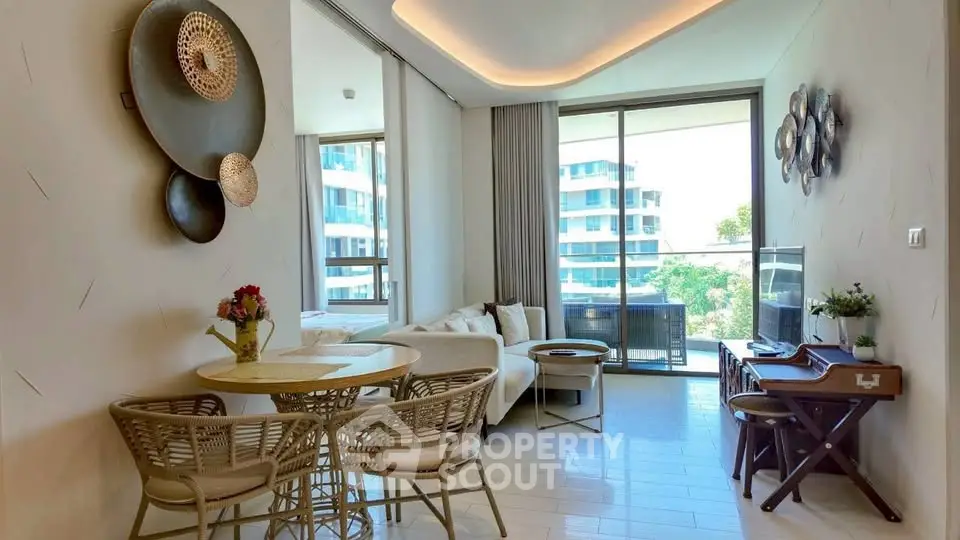 Stylish living room with modern decor and large windows offering a scenic view, perfect for relaxation.