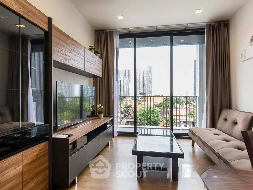 Modern living room with large windows and city view, featuring sleek furniture and wooden accents.