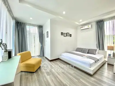 Spacious modern bedroom with large windows and stylish decor