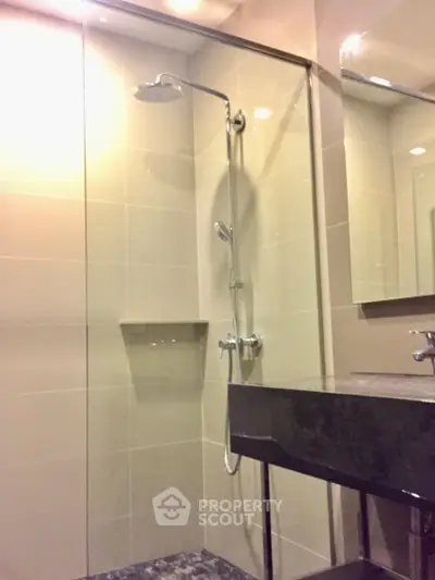 Modern bathroom with sleek shower and elegant fixtures in a contemporary home.