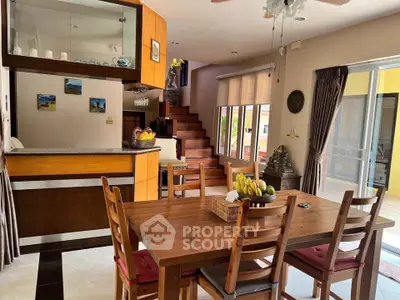 Charming dining area with wooden furniture and open kitchen layout in a cozy home setting.