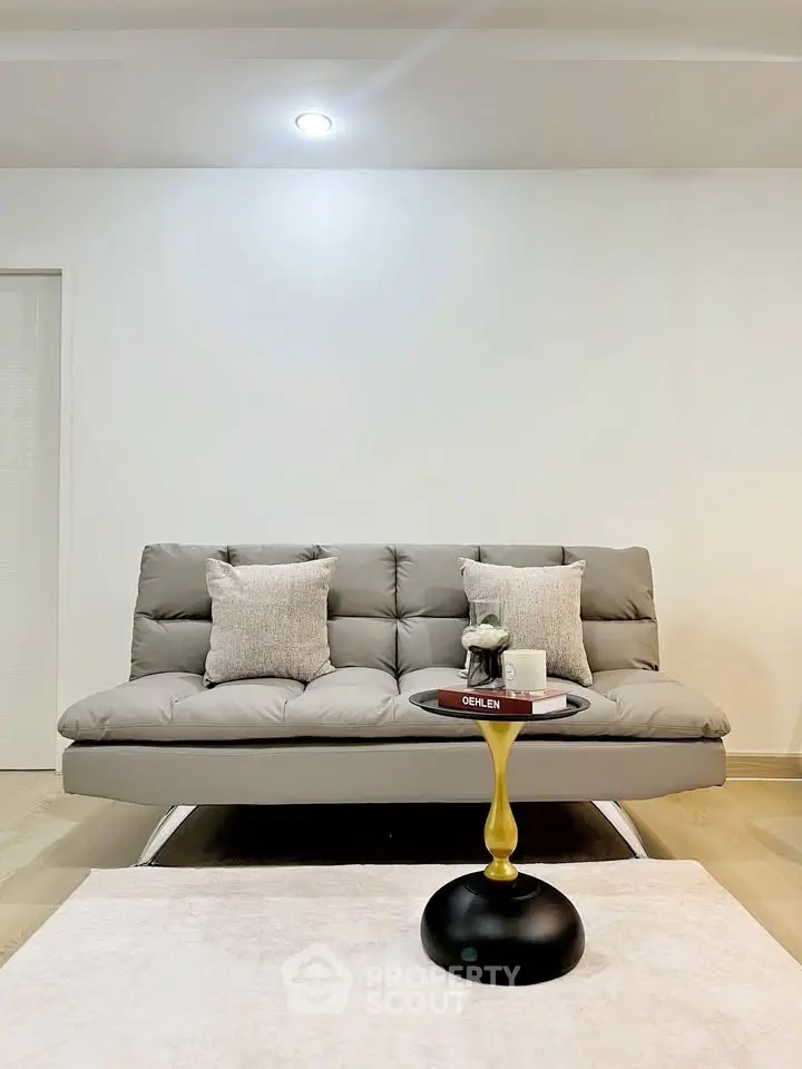 Modern living room with stylish gray sofa and elegant coffee table