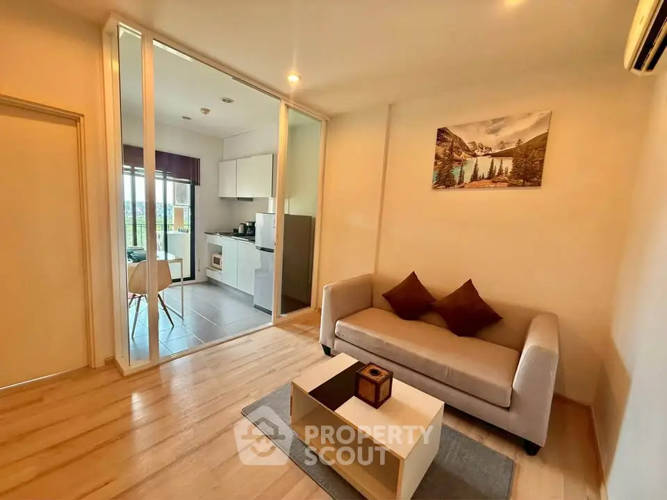 Modern living room with open kitchen and scenic view, featuring cozy sofa and stylish decor.
