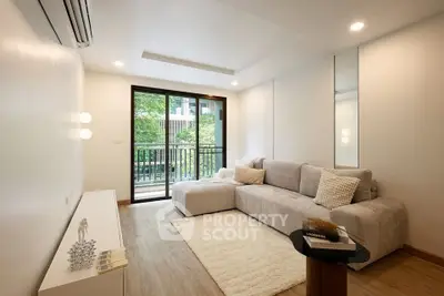 Modern living room with cozy sectional sofa and balcony view in a stylish apartment.