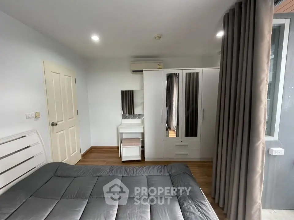 Cozy bedroom with modern furniture and ample natural light
