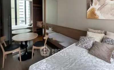 Modern bedroom with stylish decor and balcony view in urban apartment