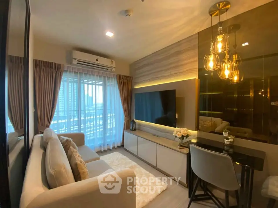 Modern living room with elegant lighting and city view, featuring cozy seating and stylish decor.