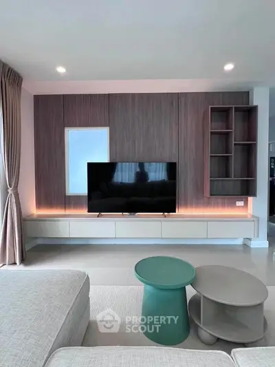 Modern living room with sleek TV unit and stylish furniture