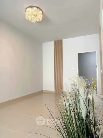 Spacious modern living room with elegant chandelier and stylish decor