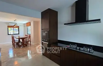 Modern kitchen with gas stove and dining area in open layout
