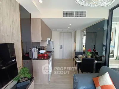 Modern open-plan living room and kitchen with sleek design and stylish decor.