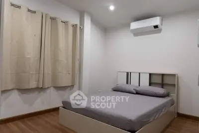 Cozy bedroom with modern air conditioning and elegant curtains, perfect for restful nights.