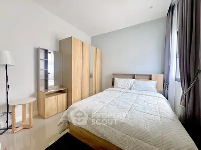 Modern bedroom with stylish wooden furniture and cozy bedding