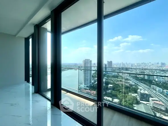 Luxurious high-rise apartment with stunning city and river views through floor-to-ceiling windows.