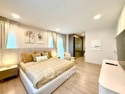 Luxurious bedroom with modern decor, large bed, and elegant lighting in a stylish apartment.