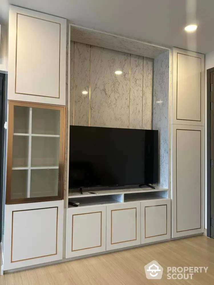 Modern living room with sleek TV unit and marble accents