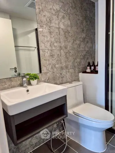 Modern bathroom with sleek fixtures and stylish tile design, perfect for contemporary living.