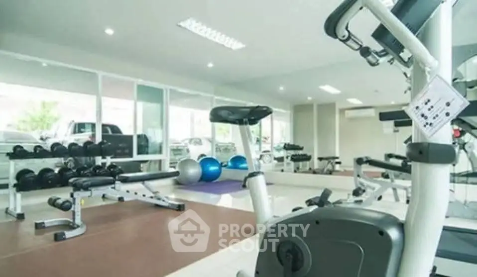 Modern gym with state-of-the-art equipment in a bright, spacious setting.