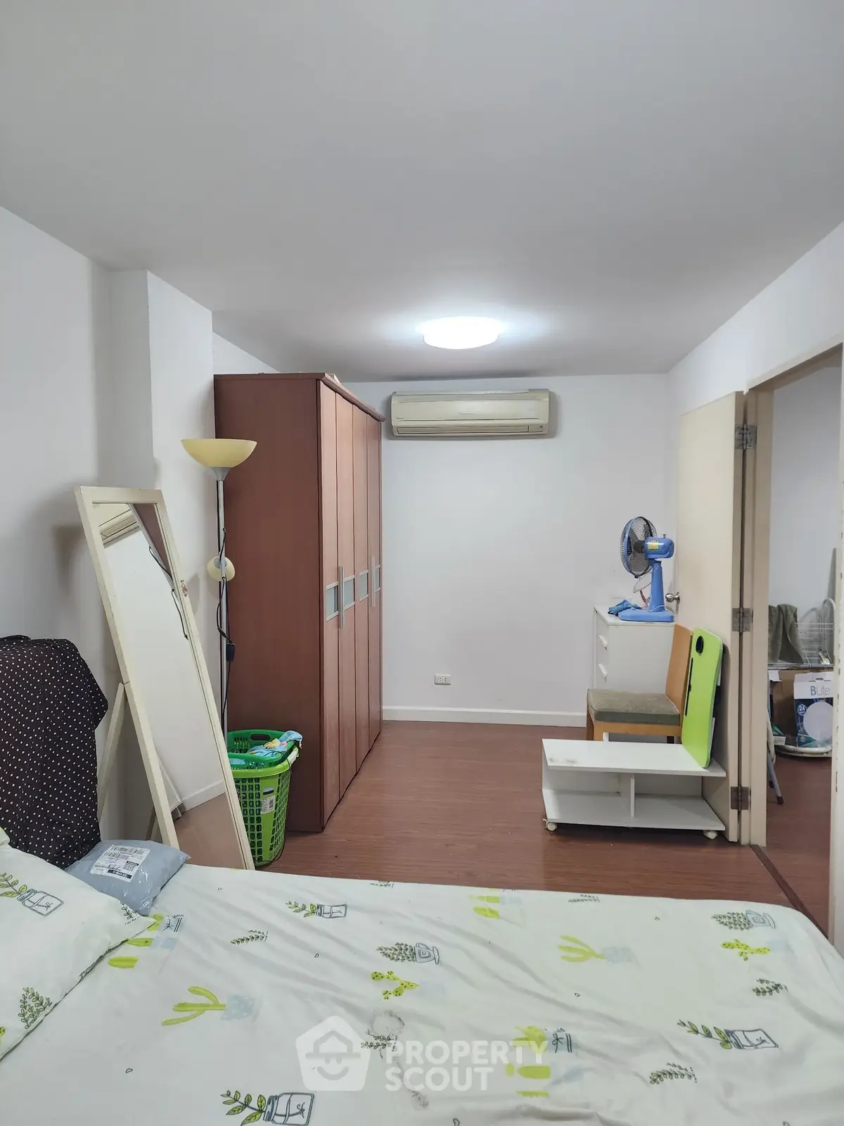 Spacious bedroom with modern decor and ample storage in a cozy apartment.
