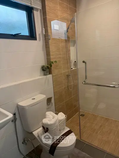 Modern bathroom with glass shower and stylish tile design