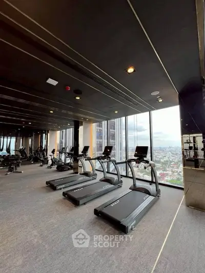 Luxurious high-rise gym with panoramic city views and modern fitness equipment.