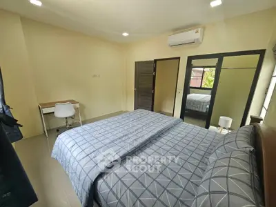 Spacious bedroom with modern decor and ample natural light